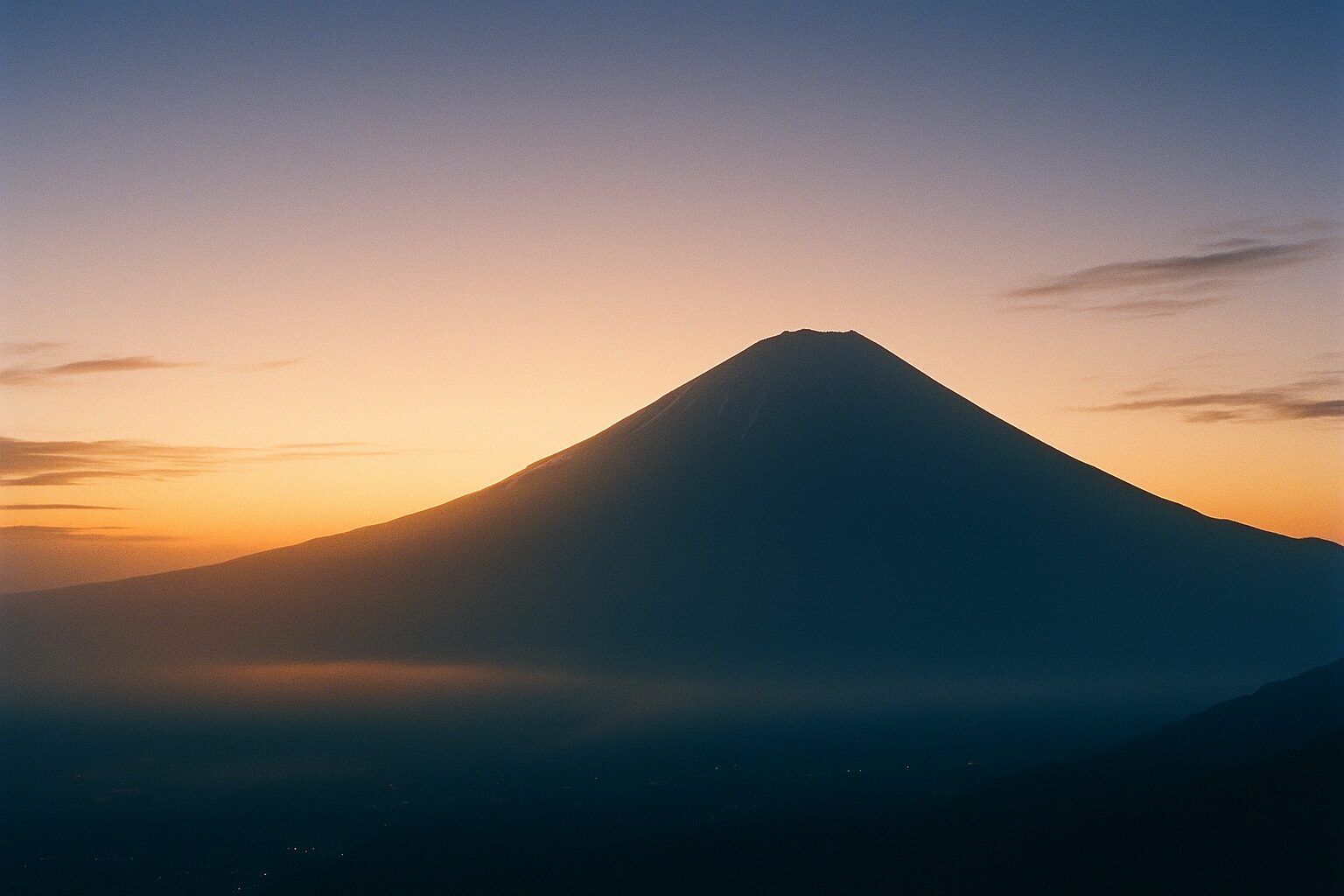 Soft dawn light over Mt. Fuji symbolizing quiet return to daily life after meditation