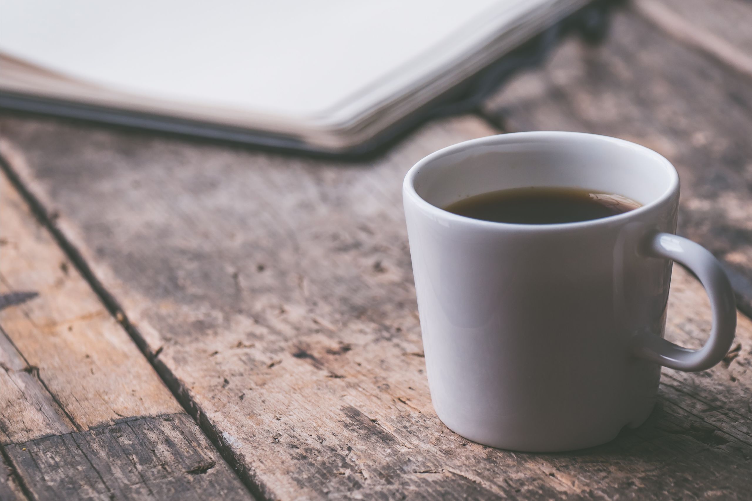 Morning coffee on a wooden table symbolizing calm focus and daily mindfulness practice beyond motivation.